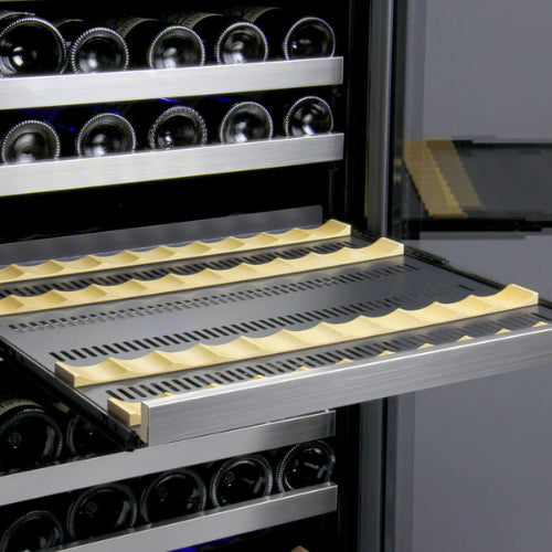 Stainless steel single zone wine refrigerator by Allavino featuring UV-protected glass, soft blue lighting, and sleek wood-accented shelving in a modern build.