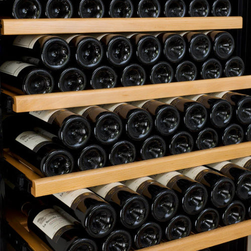 Luxury black single zone wine refrigerator by Allavino, featuring a UV-resistant glass door, wood-accented shelving, and elegant LED lighting in a high-end interior setting.